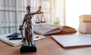 Small Lady of Justice statue sitting on top of the desk of an Arizona birth injury lawyer